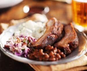 BBQ ribs and sides at a restaurant.