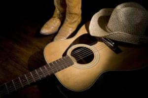Country music with cowboy hats, boots, and guitar