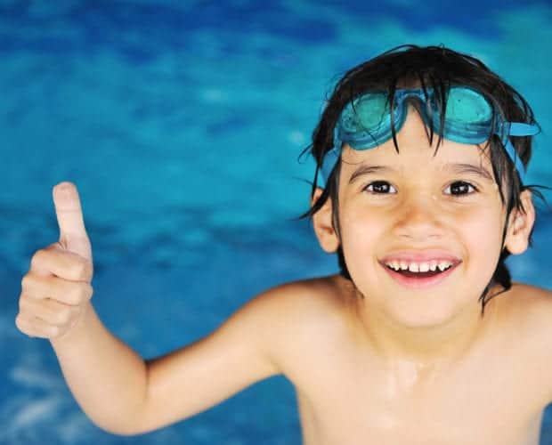 Little boy at an indoor swimming pool at the Oak Tree Lodge