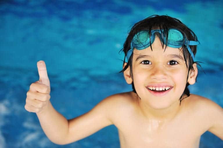 Little boy at an indoor swimming pool at the Oak Tree Lodge