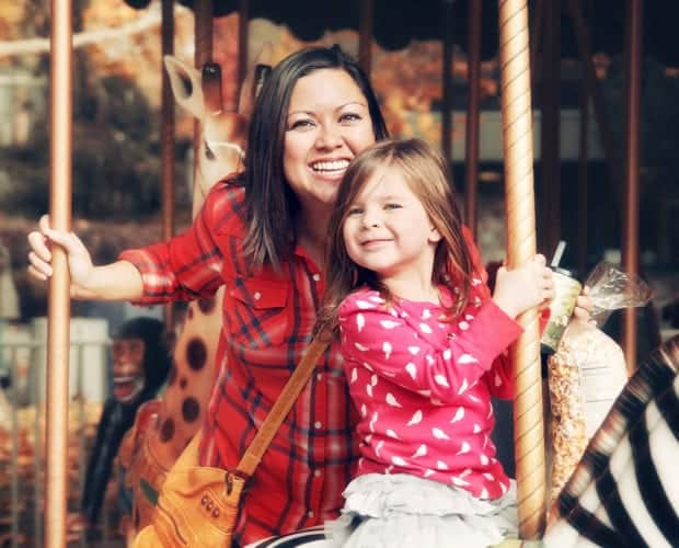 Mother and daughter riding a merry go round at Dollywood in Pigeon Forge