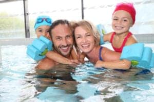 A family swimming together at our Pigeon Forge hotel with indoor pool.