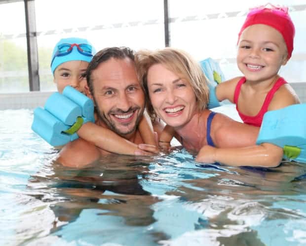 A family swimming together at our Pigeon Forge hotel with indoor pool.