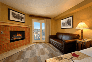 A hotel room at the Oak Tree Lodge with a fireplace.