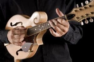 A man playing a mandolin.
