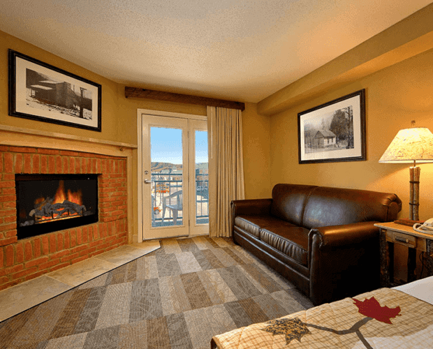 A Pigeon Forge TN hotel room with a sofa and fireplace.