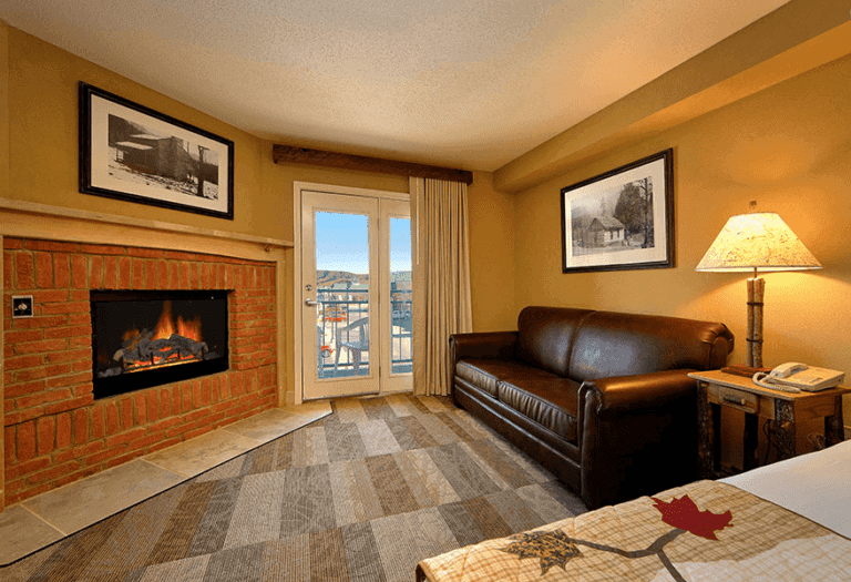A Pigeon Forge TN hotel room with a sofa and fireplace.