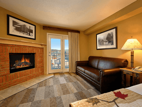 hotel room with a couch and fireplace