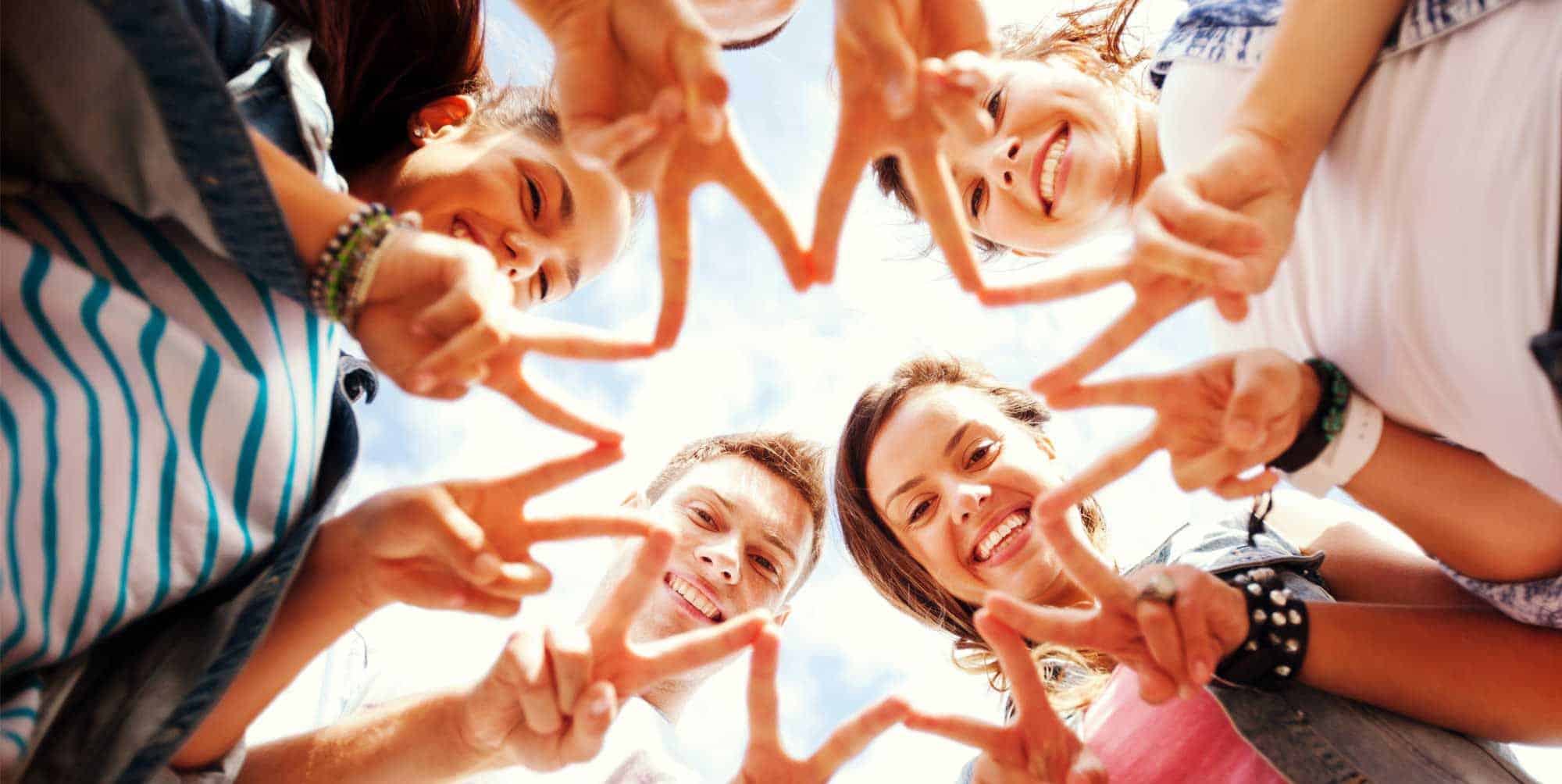 people in a group touching fingers