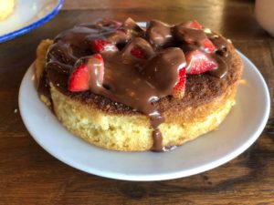 pancake covered in chocolate syrup and strawberries from five oaks farm kitchen